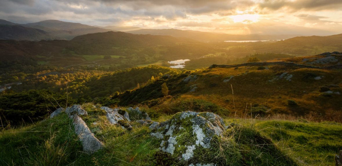Photo from high perspective of the lake district at sunset
